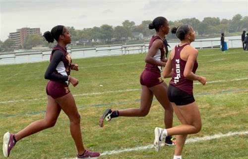 Girls cross country team running on track